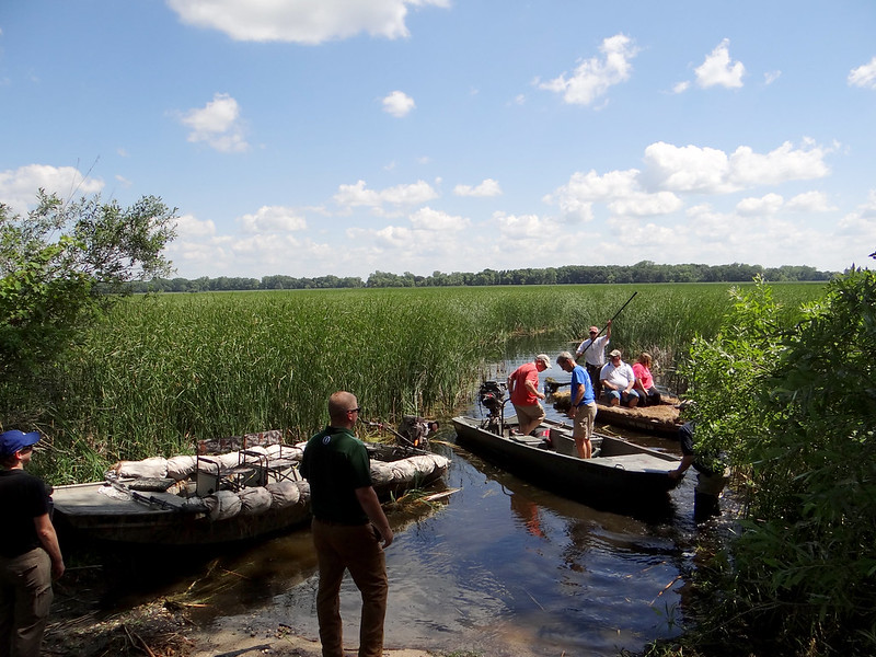 Attendees tour enhanced Eagle Lake on three boats.