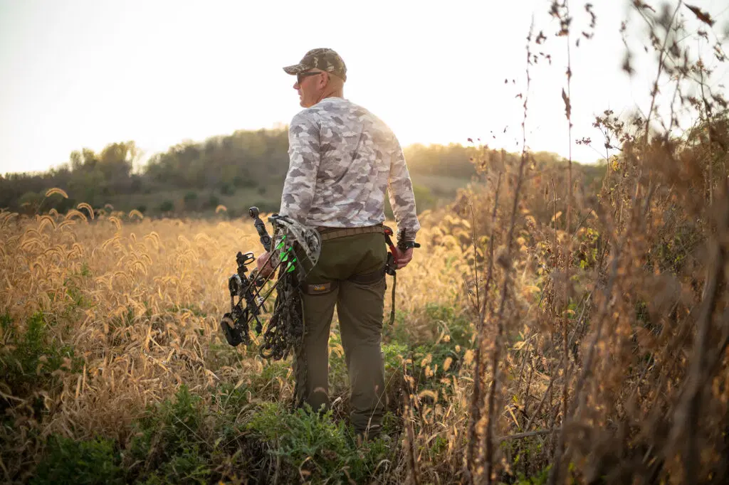 Crossbow hunter in grasslands at Medford WMA.