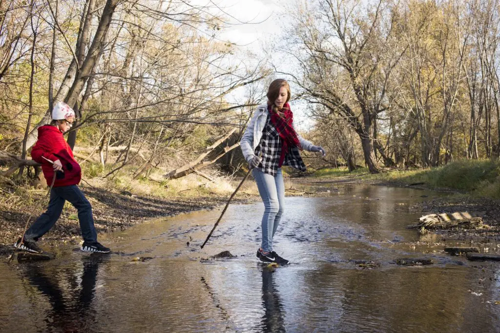 Visitors explore a stream within the Metro Big Rivers area.