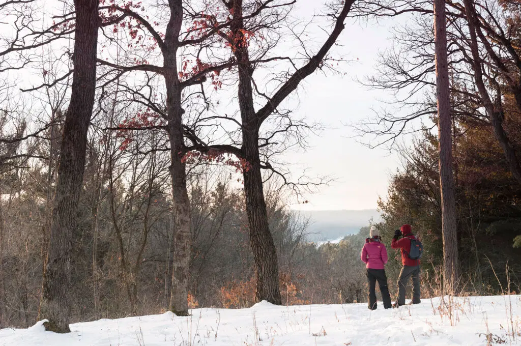 Visitors look out atop a hill within the St. Croix watershed area during winter.
