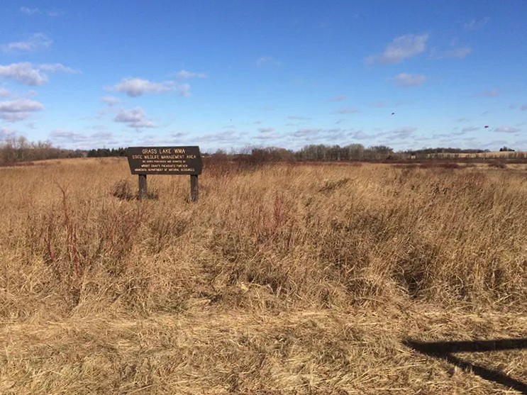 Signage within grasslands at Grass Lake WMA.