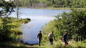 Visitors walk up a hill near the Lester Lake shoreline.